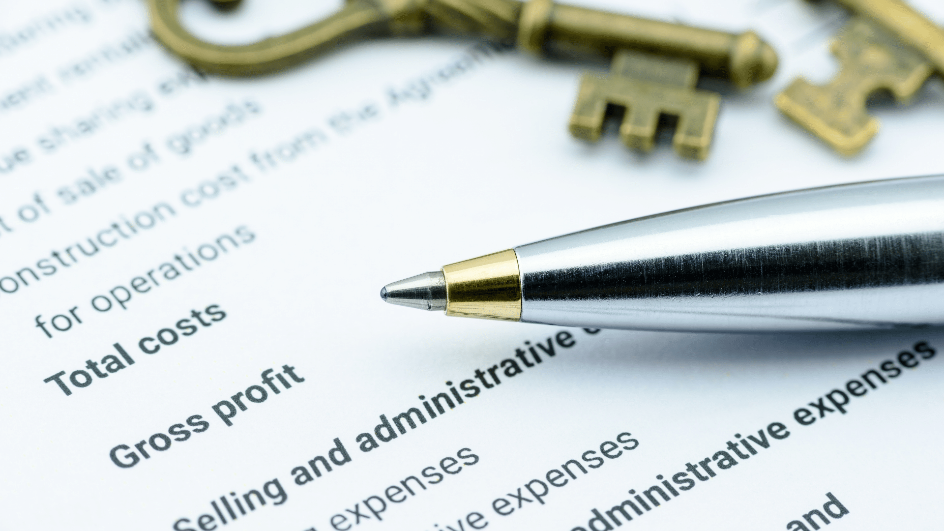 An image of an incorporated business's financial document with a pen and keys sitting on top of the paper