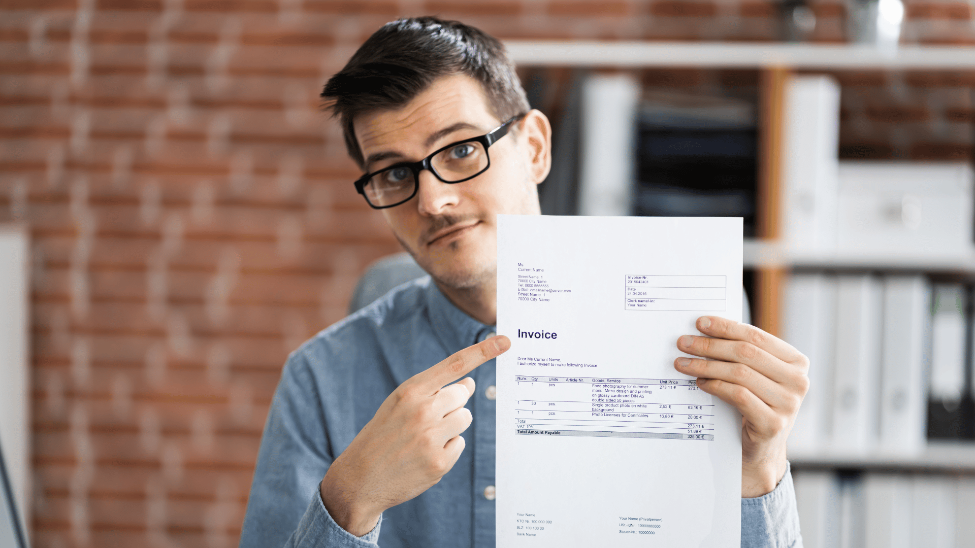 An image of an Ottawa business owner pointing to an invoice which includes his GST/HST amounts