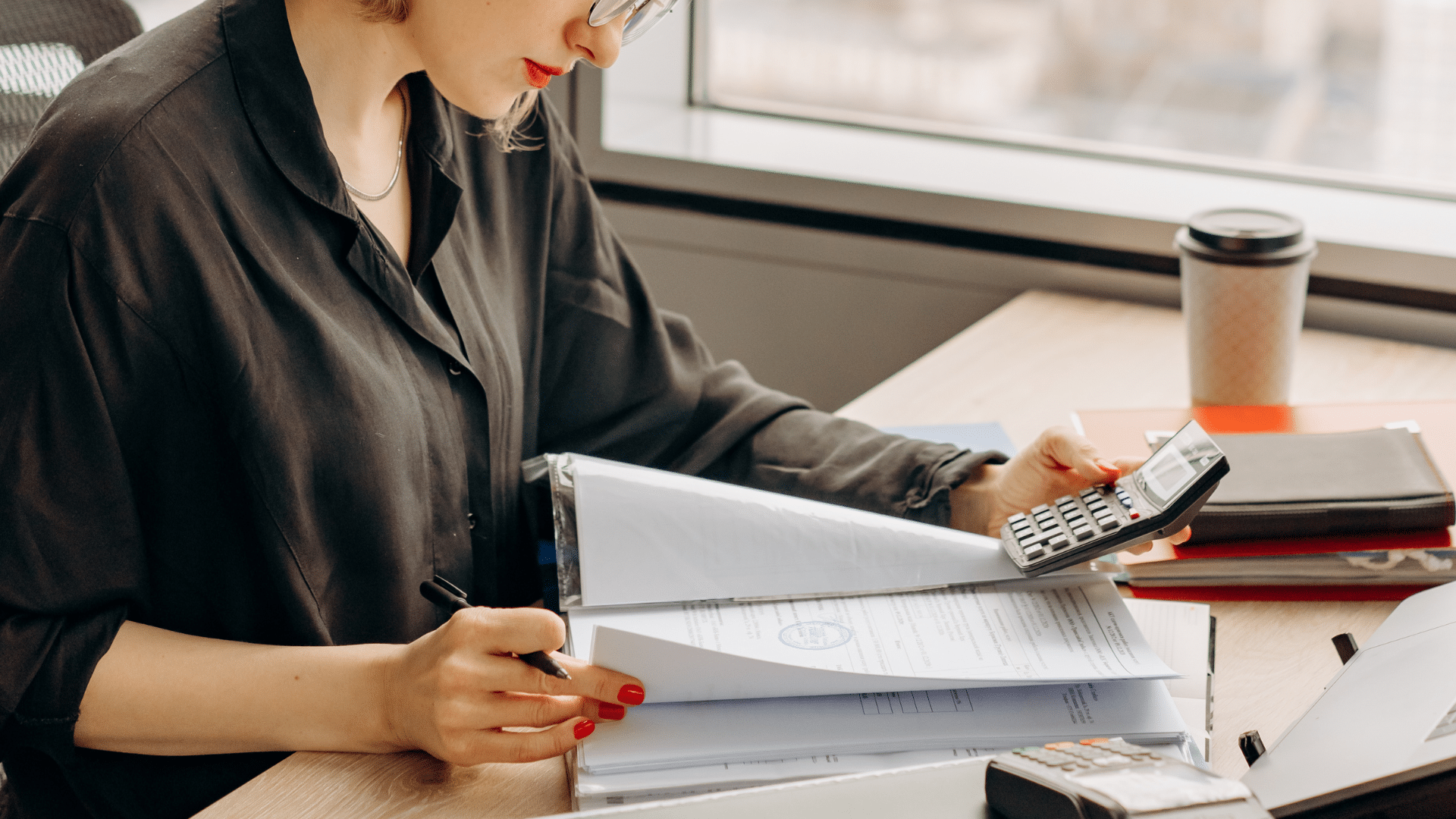 An image of a small business accountant reviewing client files.